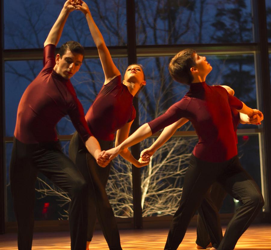 four dancers holding hands ina circle